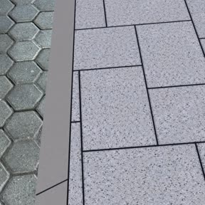 An der Kante zugeschnittene Steine neben dem vorhandenen Belag